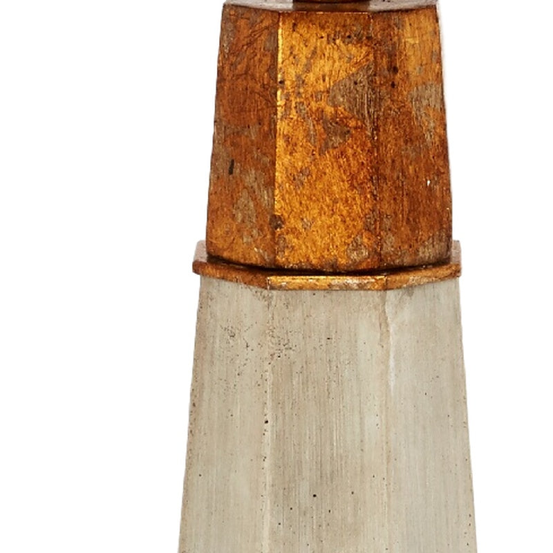 Hexagonal table lamp base detail: beige cement with rust-brown upper band and gold