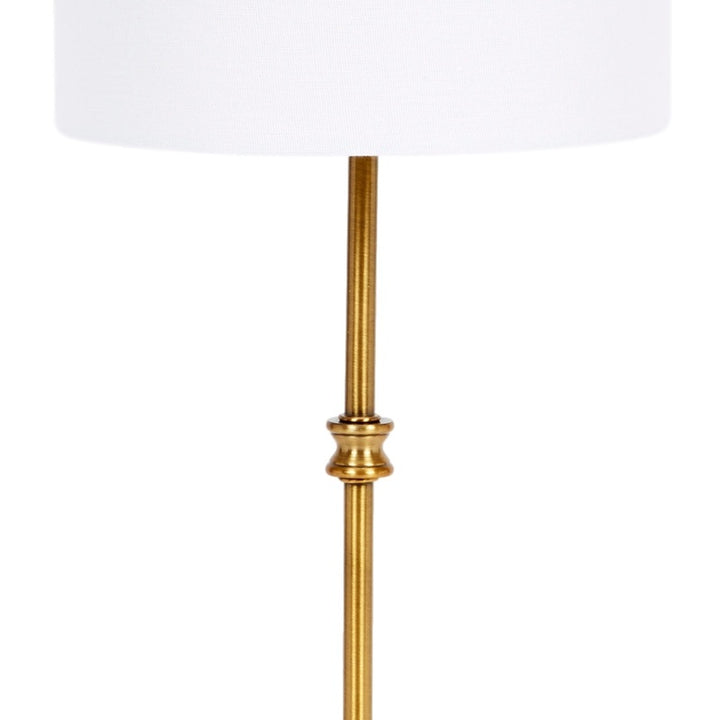 Gold metal lamp stem with decorative collar, paired with white drum shade