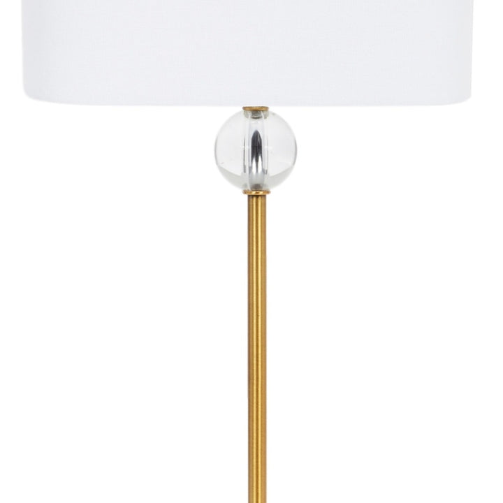 White linen lamp shade and clear glass bulb on brass stem
