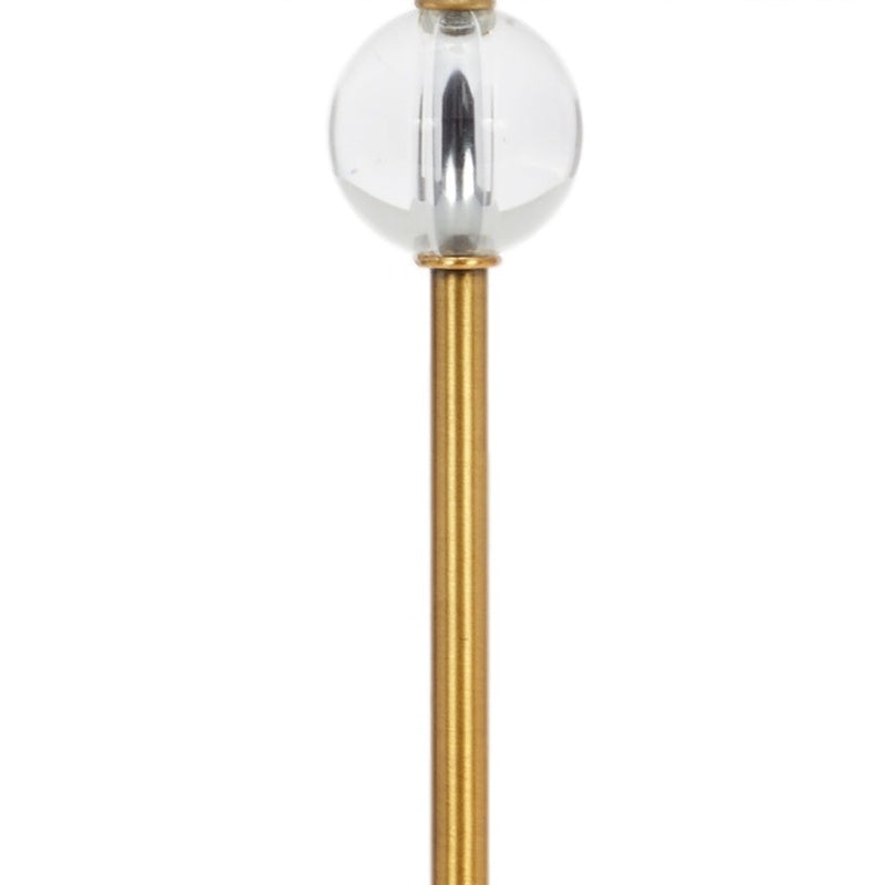 Clear glass bulb lamp detail with brass stem and small cap