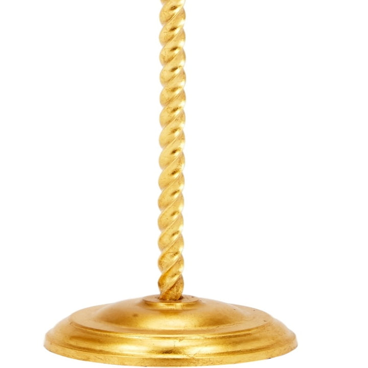 Gold round lamp base with twisted stem attachment.