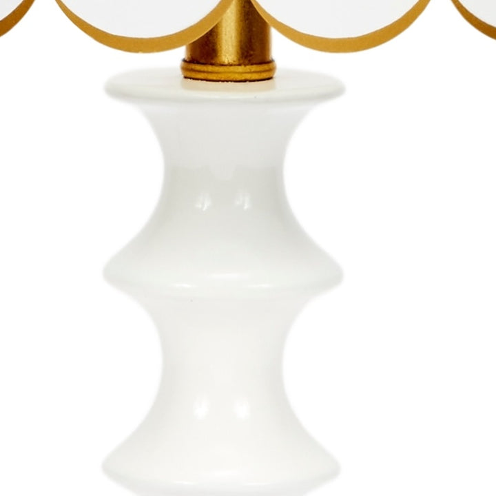 White scalloped table lamp shade with gold finial on top