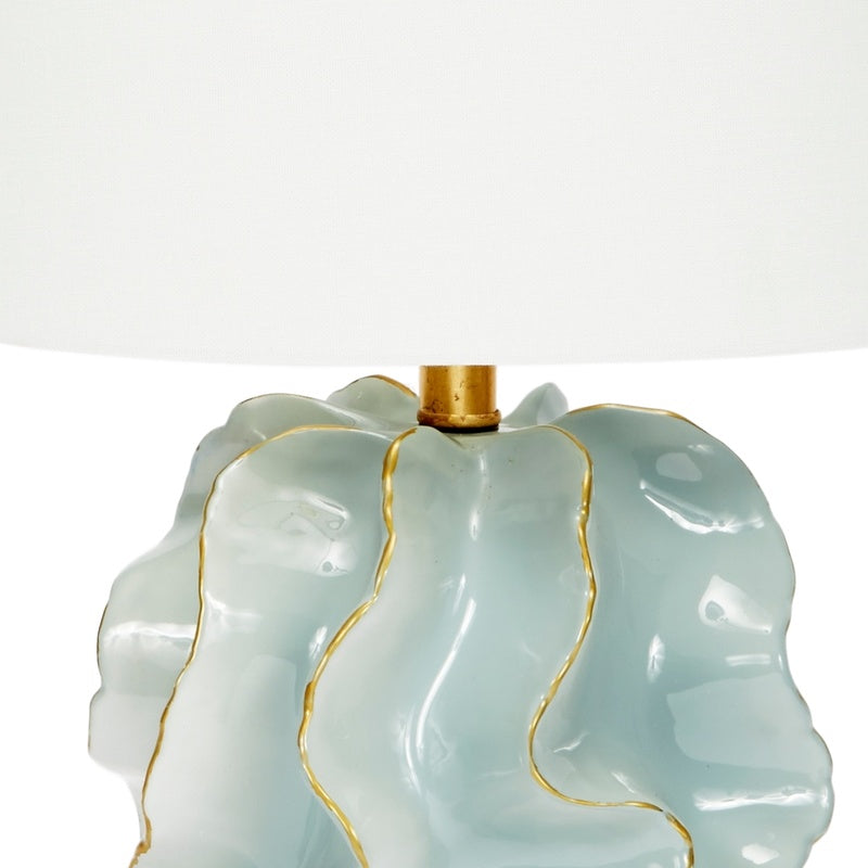 Blue ceramic lamp base with scalloped edges, gold trim, and brass neck