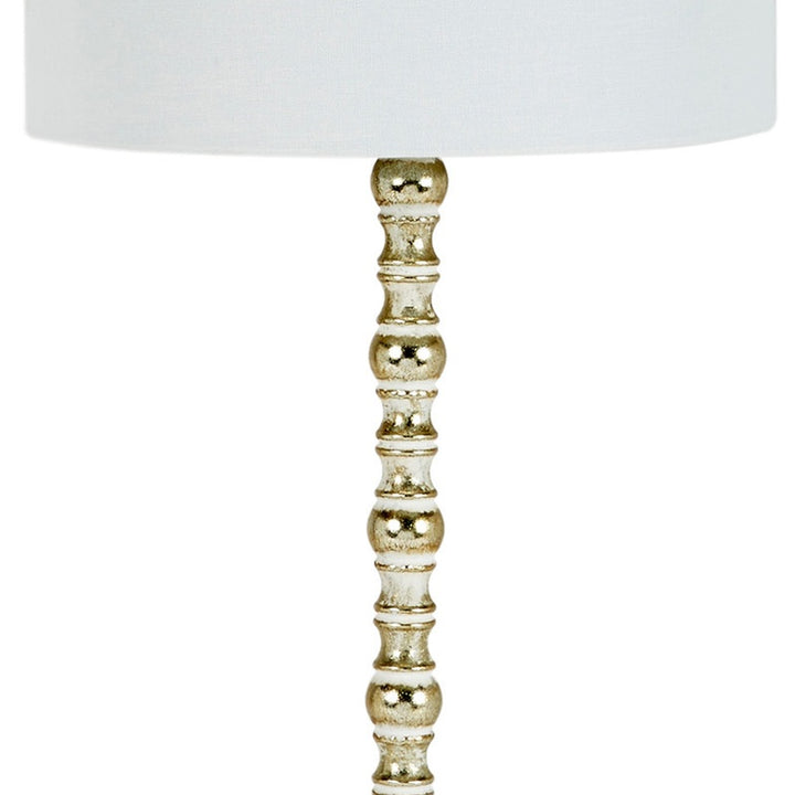 Turned gold lamp pedestal with decorative stacked spheres