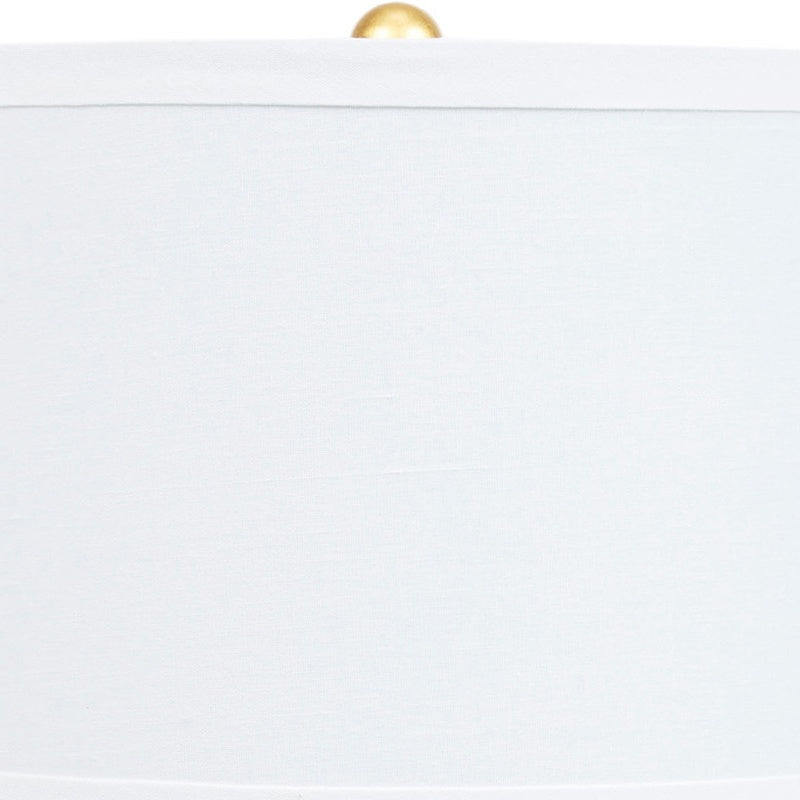 Navy blue ceramic table lamp with white shade and brass socket