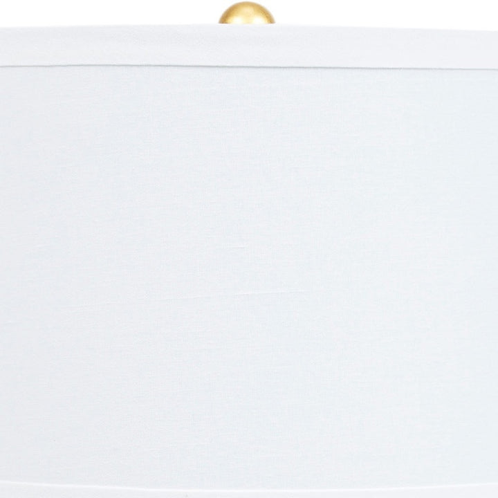 Navy blue ceramic table lamp with white shade and brass socket