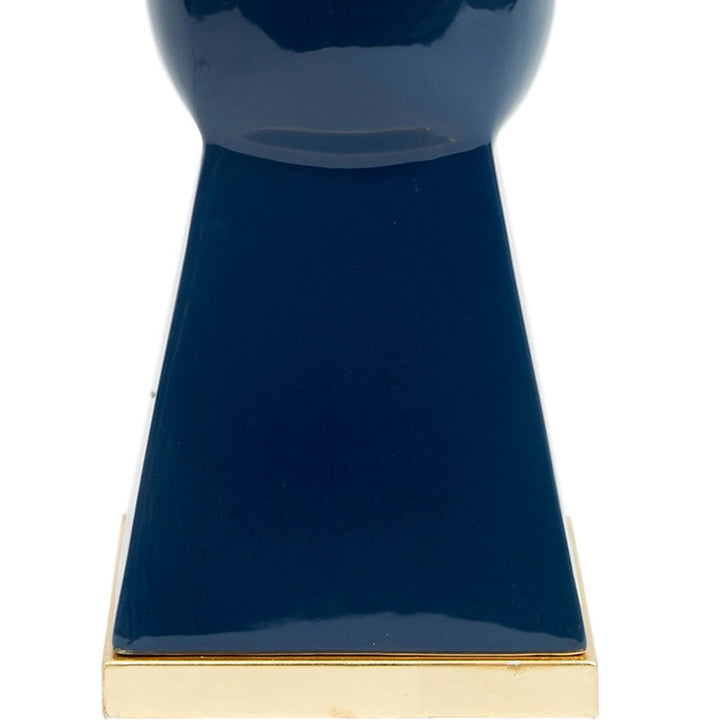 Navy blue ceramic table lamp base with brass trim and bottom edge