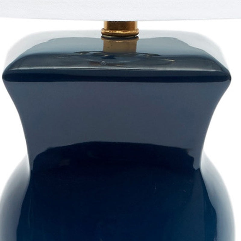 Navy blue ceramic table lamp upper body with brass socket and white shade