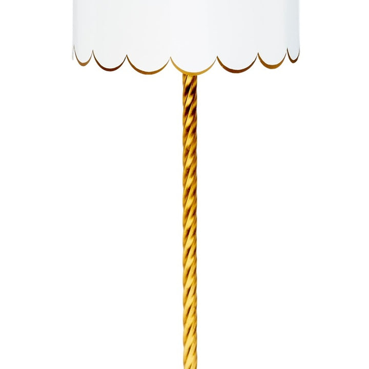 White lampshade with scalloped gold trim and twisted gold pole.