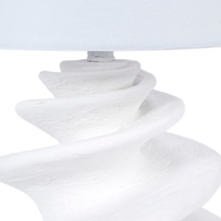 White gesso shell table lamp with linen drum shade and textured spiral pedestal
