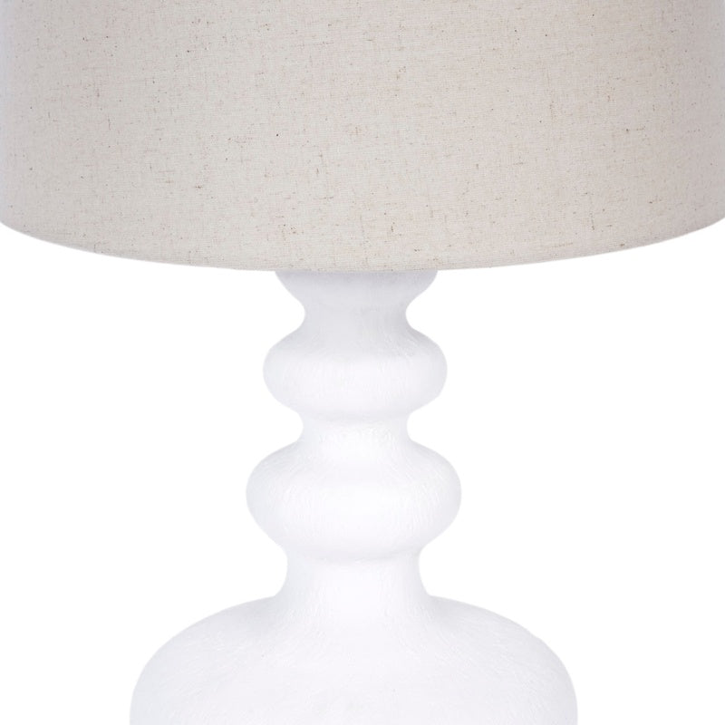 Table lamp with white gesso pedestal base and white fabric drum shade edge