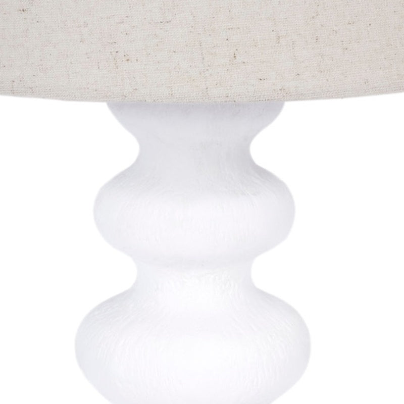 Table lamp with white gesso turned pedestal base under fabric drum shade