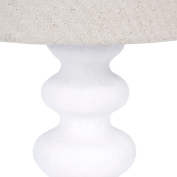 Table lamp with white gesso turned pedestal base under fabric drum shade