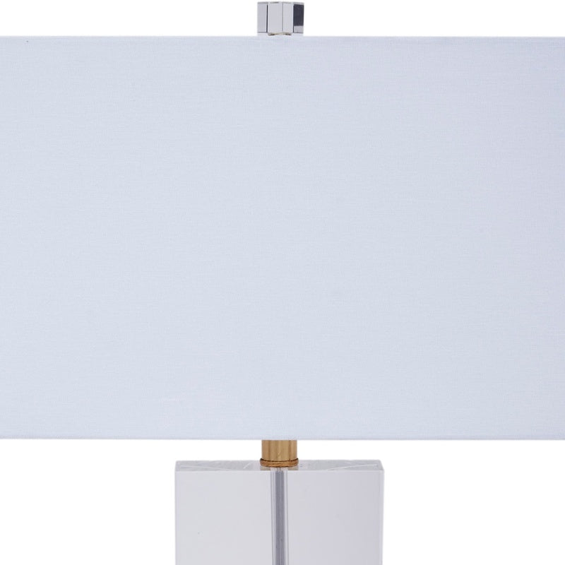 Silver table lamp with white fabric shade and gold-toned top finial
