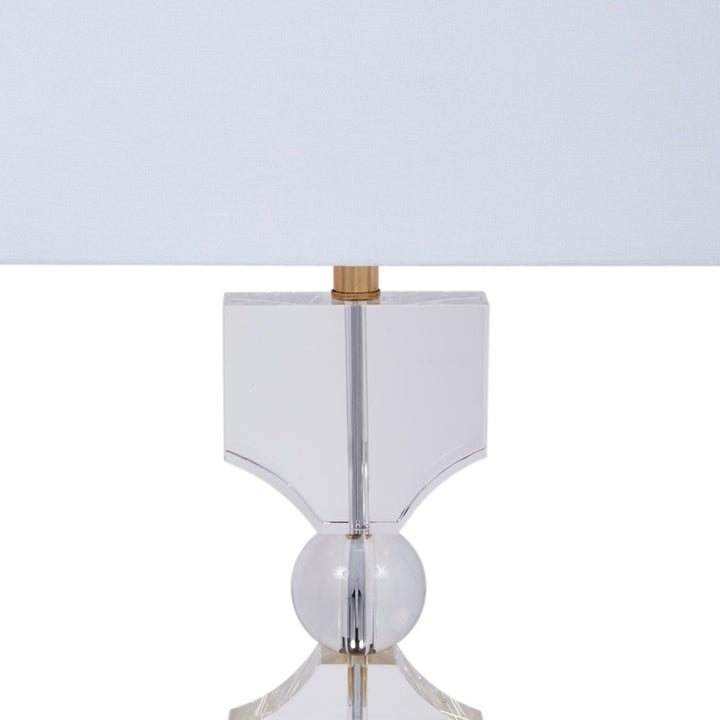 Silver table lamp with white shade, faceted crystal center and gold accents
