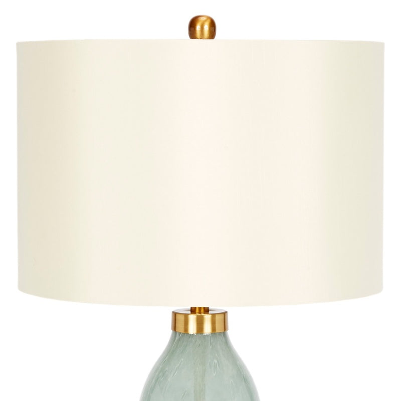 Table lamp with off-white drum shade and pale green handblown glass base