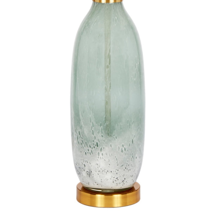 Table lamp with off-white shade, pale green glass base, and gold-tone bottom ring