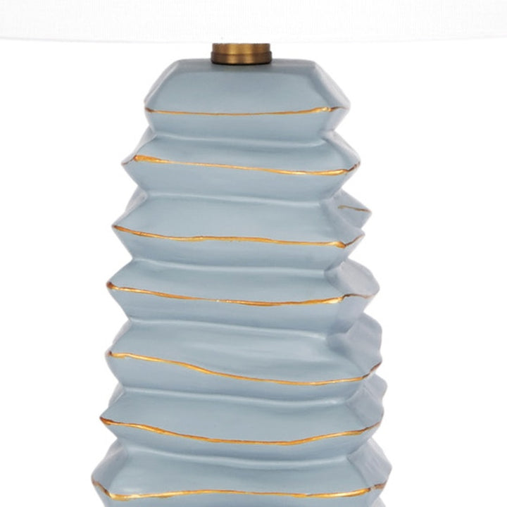 Table lamp neck and stacked soft teal tiers with gold stripe accents