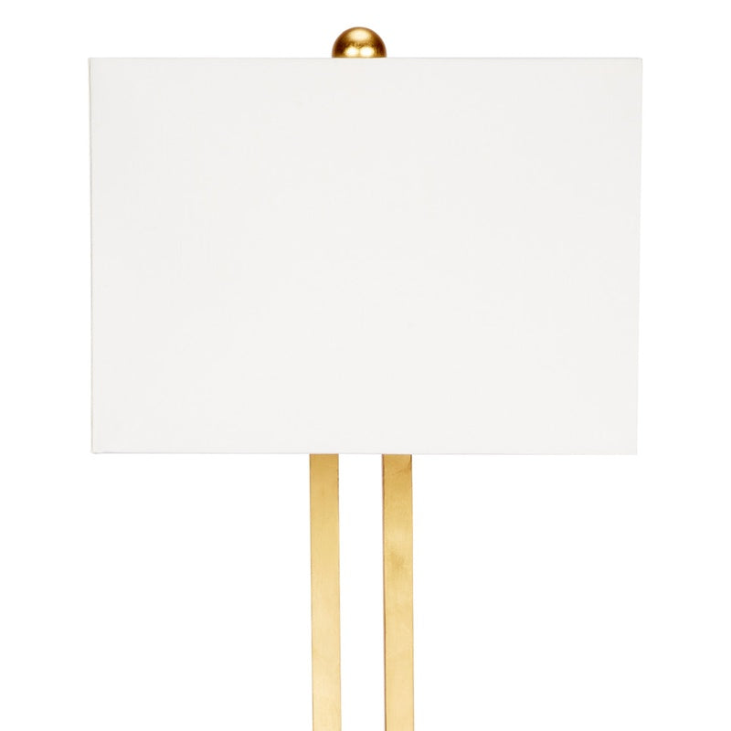 Gold table lamp with linen shade and two gold leaf vertical supports