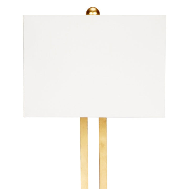 Gold table lamp with linen shade and two gold leaf vertical supports