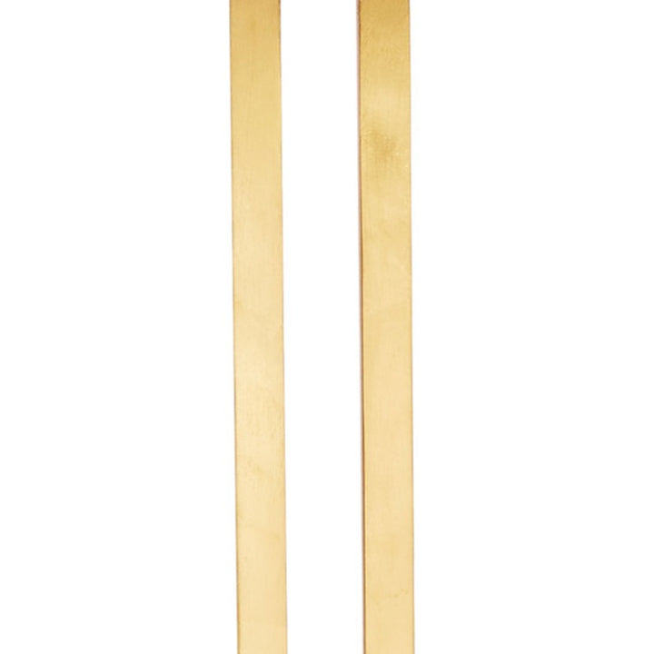 Close view of gold leaf vertical supports for a linen shade table lamp
