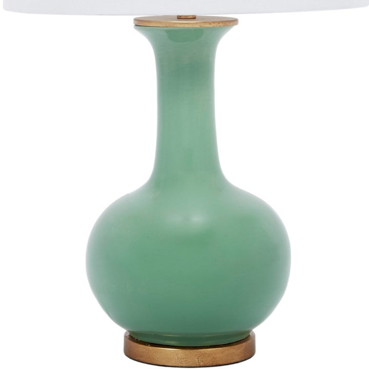 Green ceramic table lamp with white linen shade and round bulb base