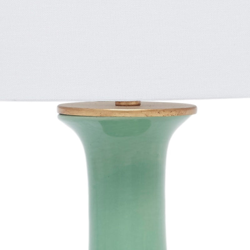 Green ceramic table lamp top with white linen shade and brass cap