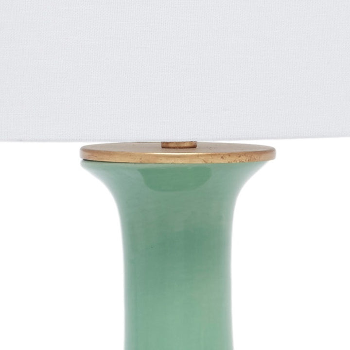Green ceramic table lamp top with white linen shade and brass cap