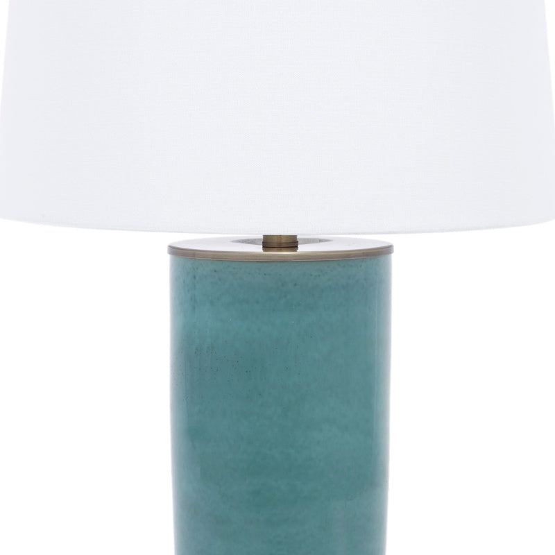 Blue ceramic lamp base with white linen shade and brass top