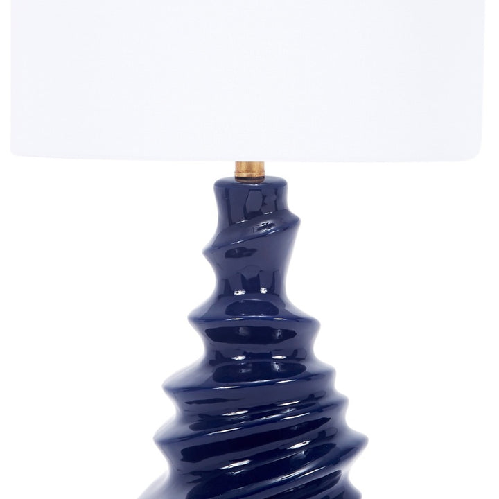 Table lamp with white drum shade and glossy navy ceramic column base