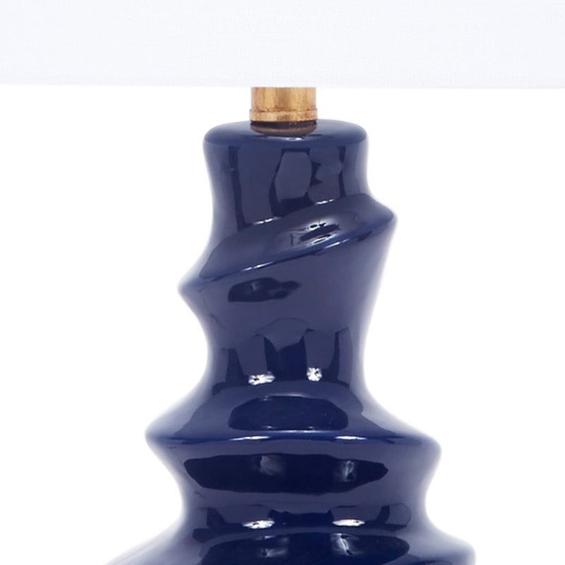 Navy ceramic table lamp top with gold-toned socket and white drum shade