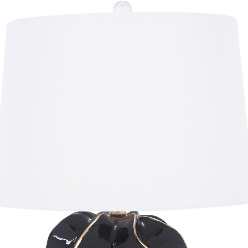 Table lamp with white shade and glossy black ceramic base, gold accent trim