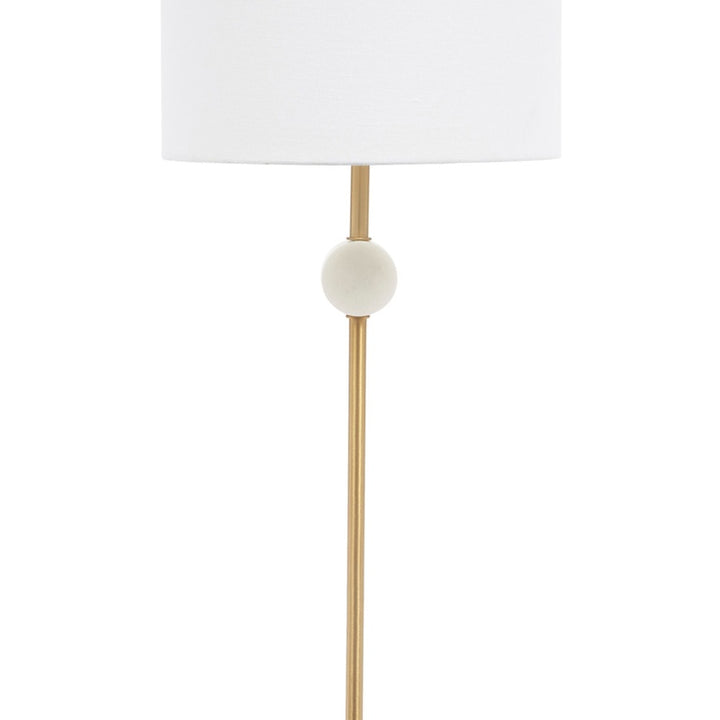 White marble disc accent on gold vertical stem under a white drum lamp shade