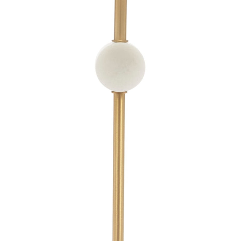 White marble disc finial on gold vertical stem below the white drum shade