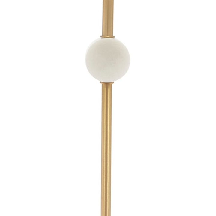 White marble disc finial on gold vertical stem below the white drum shade
