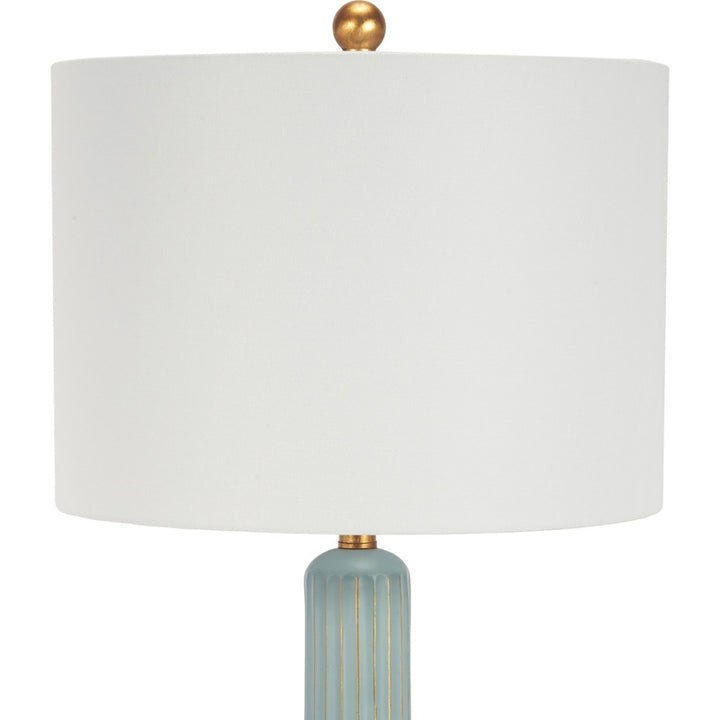 Teal table lamp with white drum shade and gold top finial