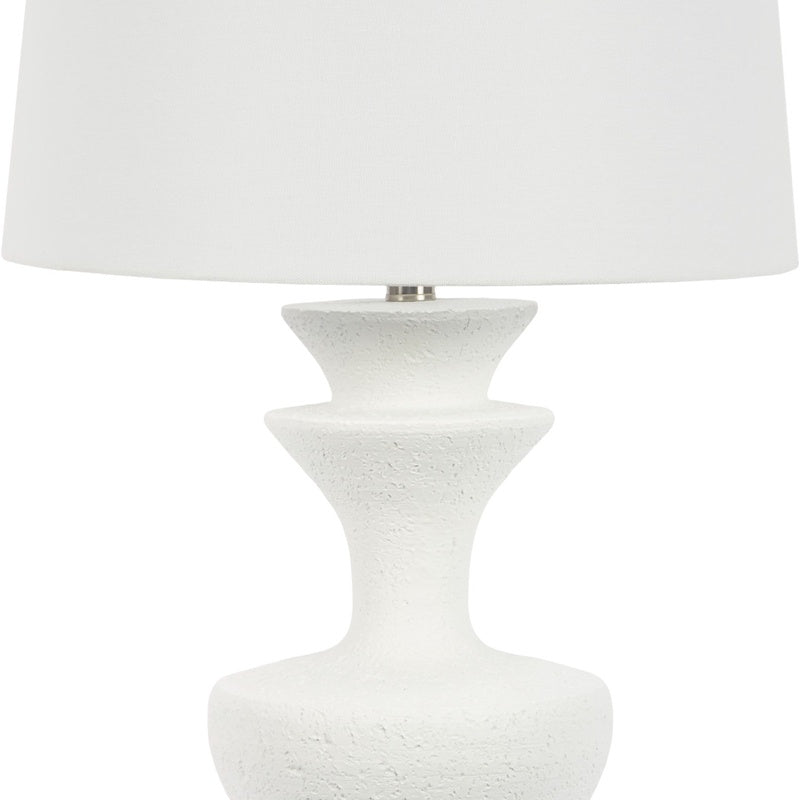 White resin table lamp, close view of white fabric shade and speckled pedestal