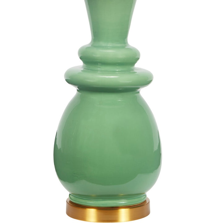 Ceramic table lamp with green ceramic base and white drum shade, brass foot