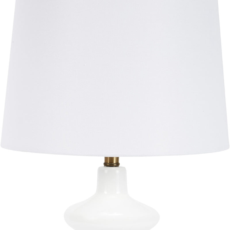 White drum shade and white glass lamp body with brass socket accents
