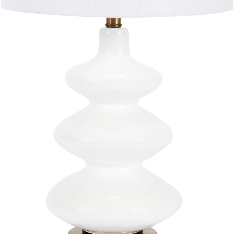 White glass table lamp base with ribbed tiers under white drum shade