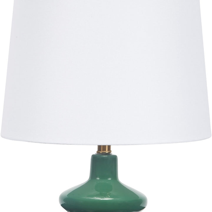Emerald green glass table lamp with white fabric shade and brass hardware
