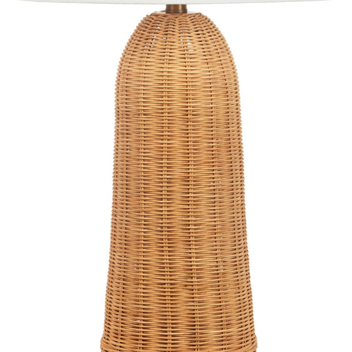 Woven rattan table lamp body under a white linen drum shade