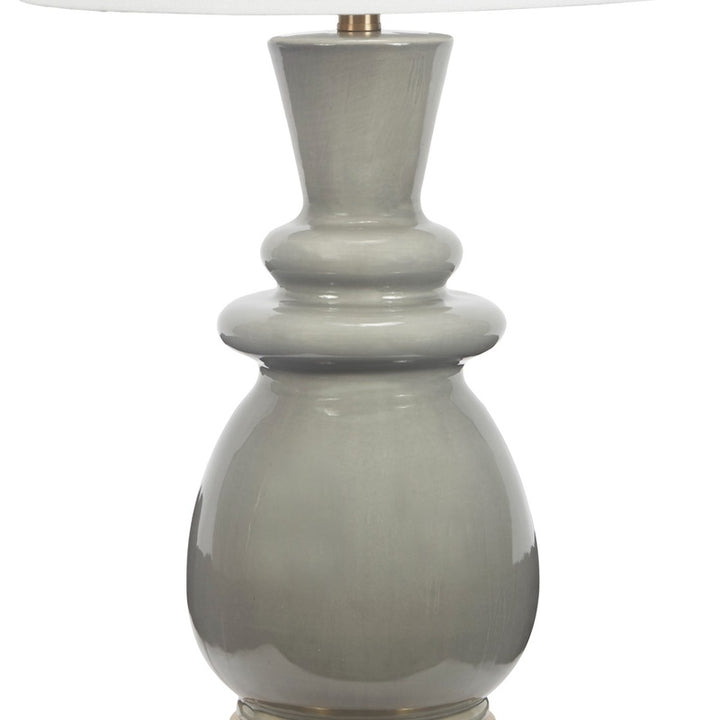 Gray ceramic lamp base with brass socket and white drum shade top