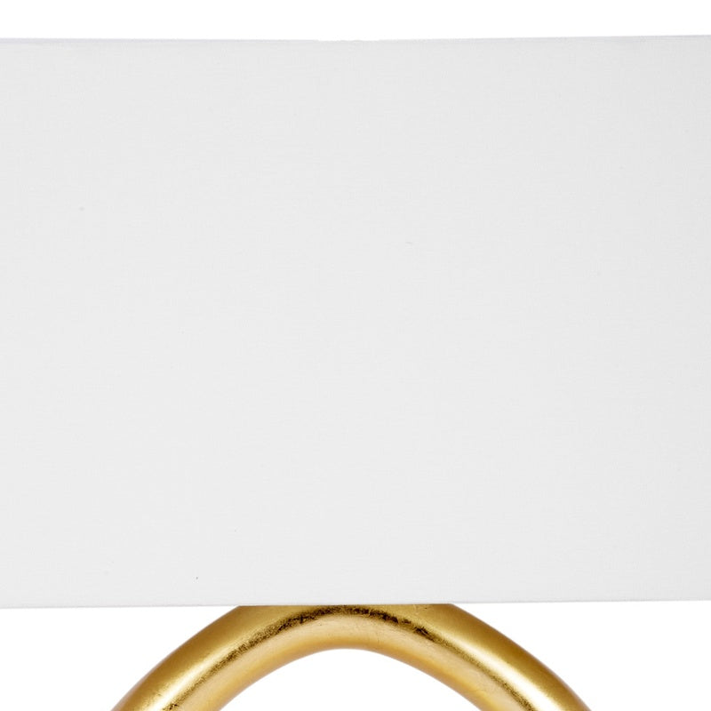 Gold table lamp frame with light-colored linen shade top
