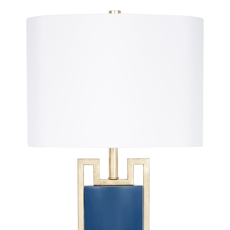 Blue table lamp with white drum shade and gold frame, blue column base.