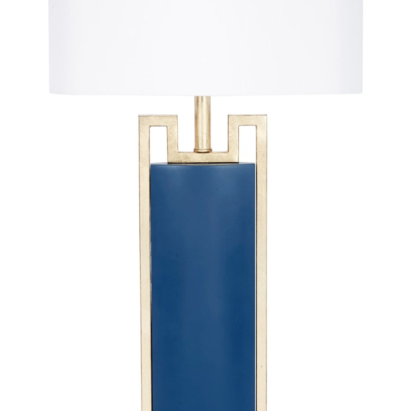 Blue table lamp with white drum shade and gold metal frame, blue column base.