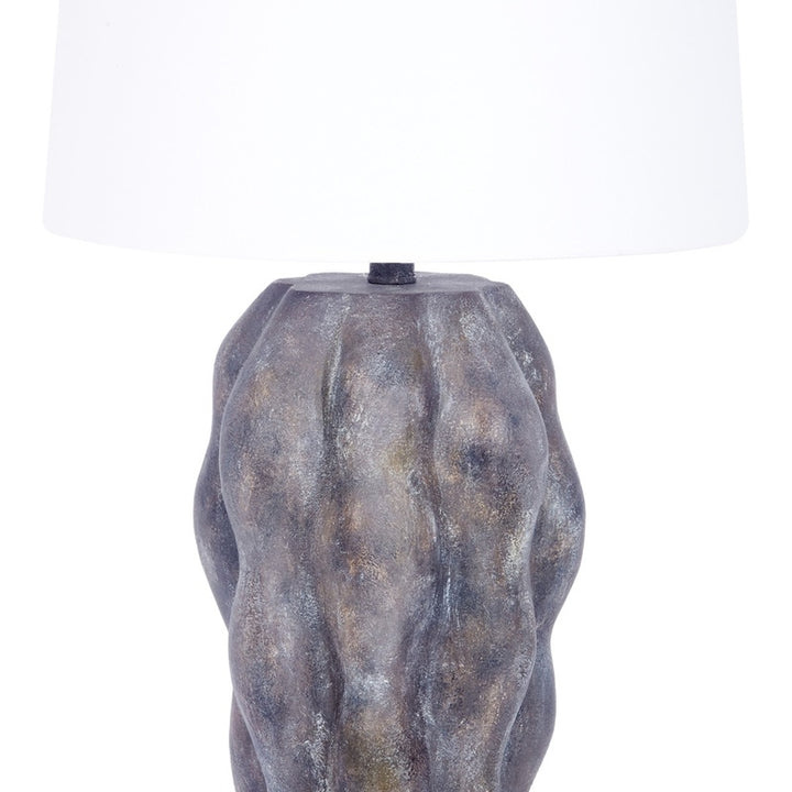 Table lamp with white linen shade over gray mottled base
