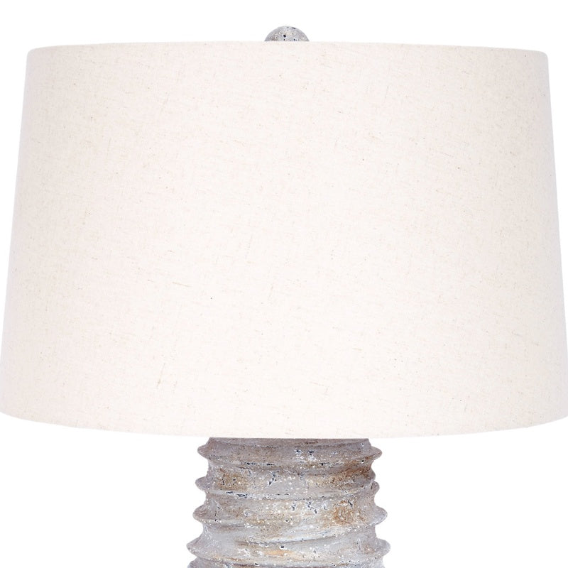 Table lamp with off-white linen shade and distressed silver base