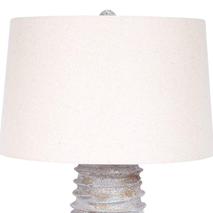 Table lamp with off-white linen shade and distressed silver base