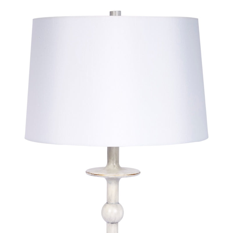 Brushed silver table lamp with white drum shade and round base